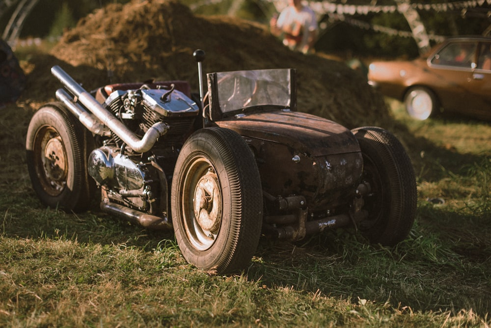 black classic car on green grass field during daytime