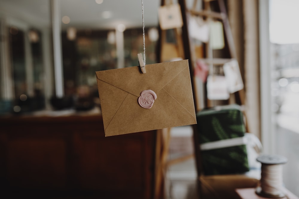 brown paper with silver round pendant