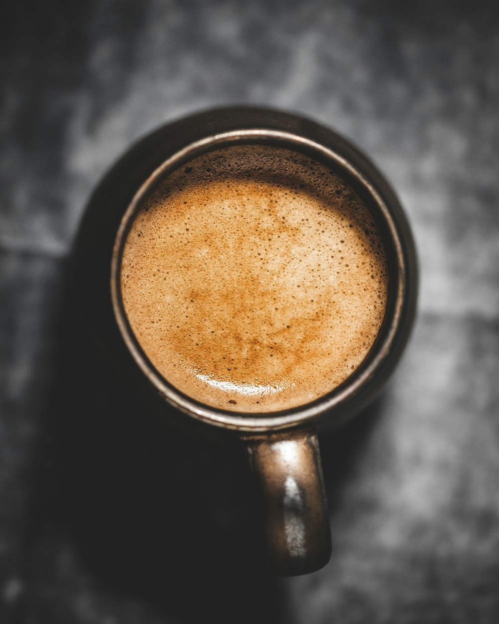 black ceramic mug with brown liquid