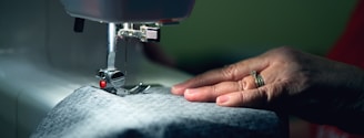 person in gray shirt sewing