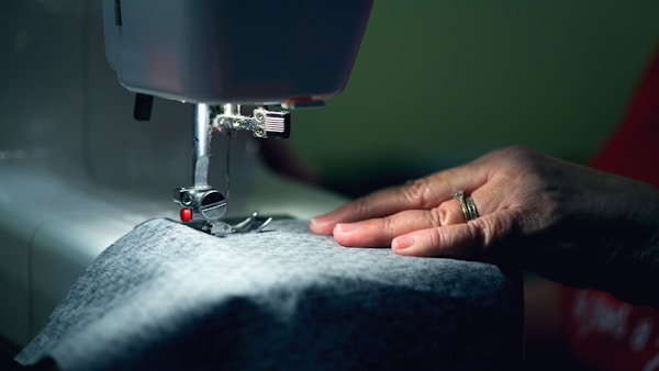 person in gray shirt sewing