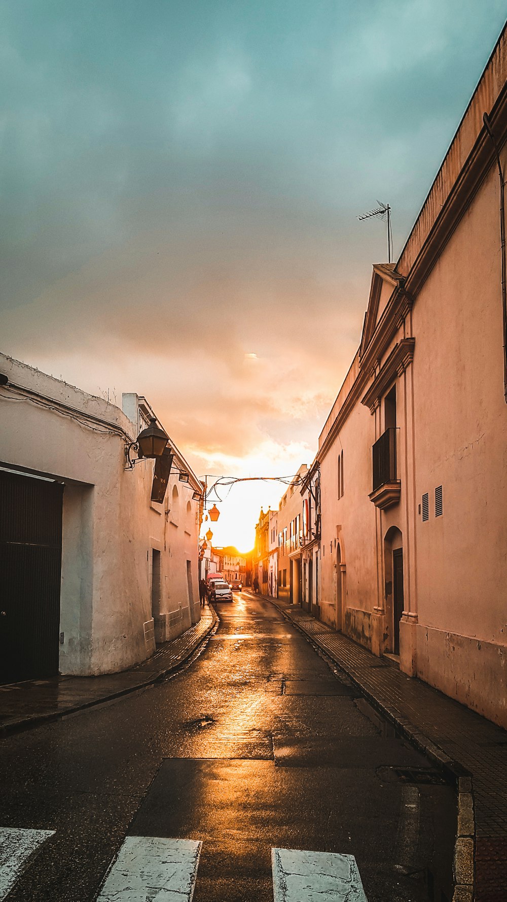 empty street between concrete buildings during daytime