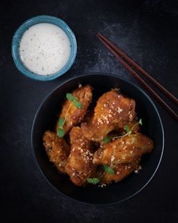 fried chicken on black frying pan
