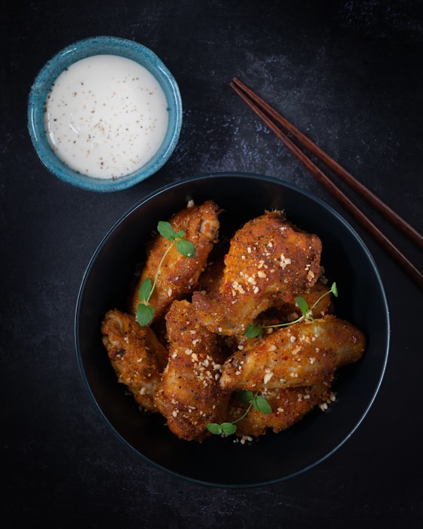 Fried chicken on black frying pan