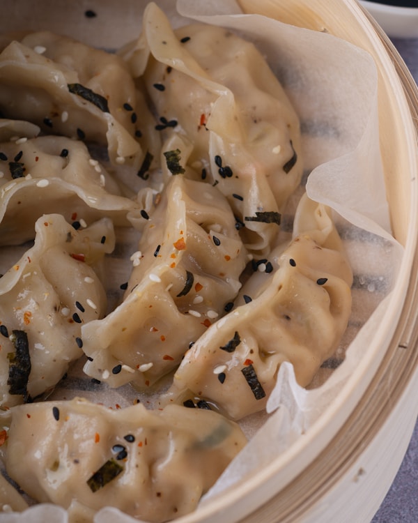 White pasta on white paper plate
