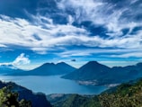 green mountains under white clouds and blue sky during daytime