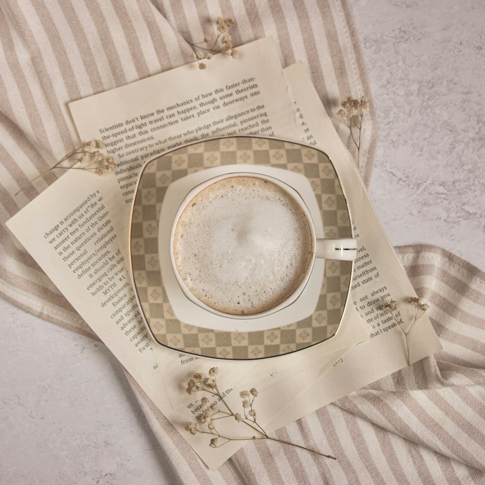 white and brown round ceramic plate on white and brown stripe table cloth