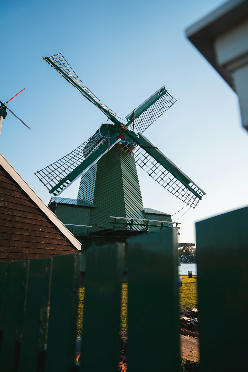 wind mill on green and yellow building during daytime