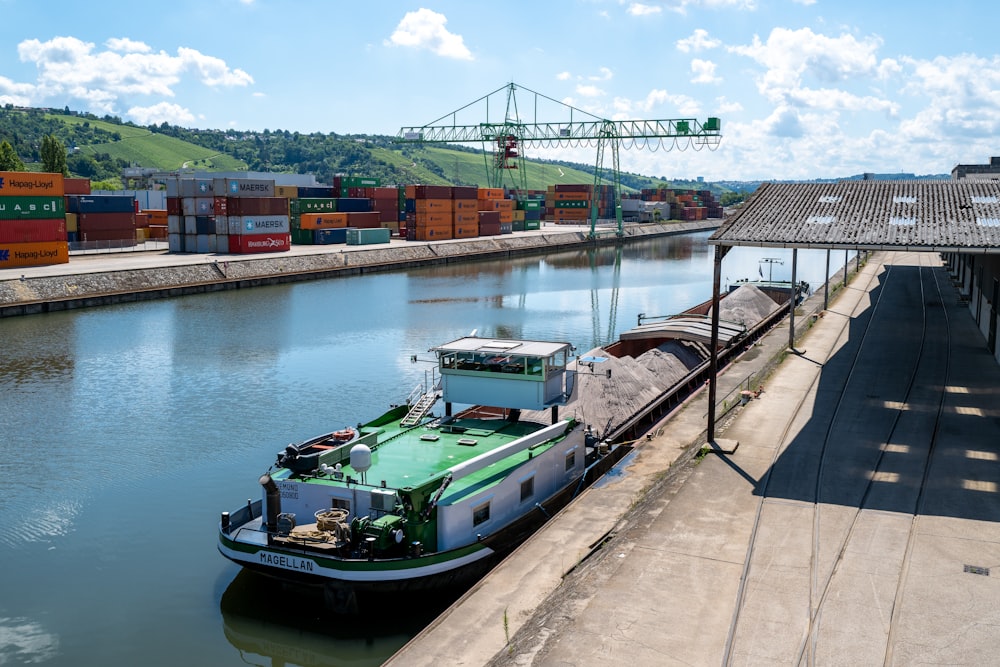 green and white boat on water during daytime