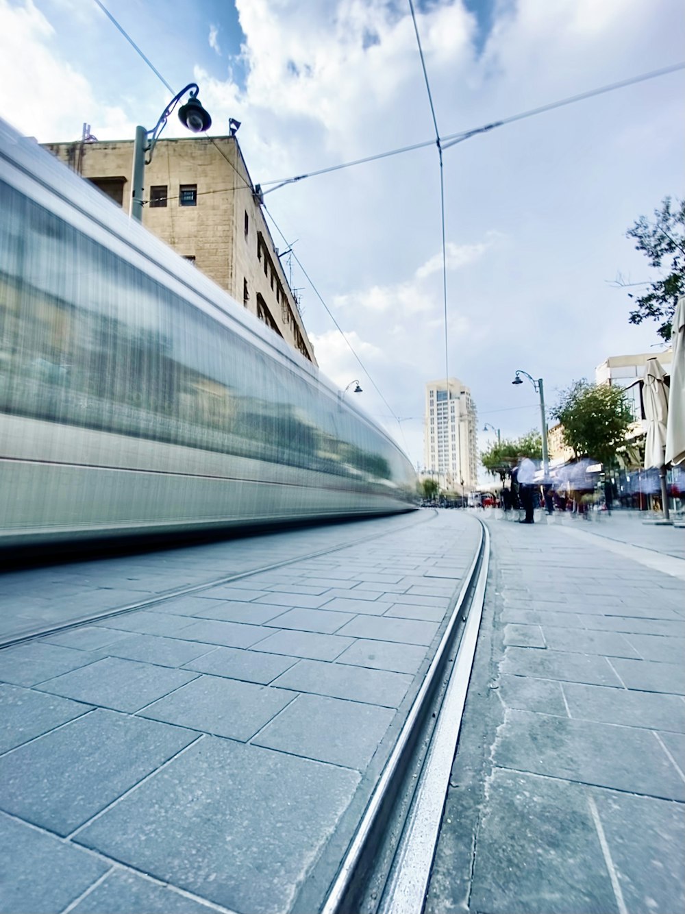 white and blue train on rail road during daytime