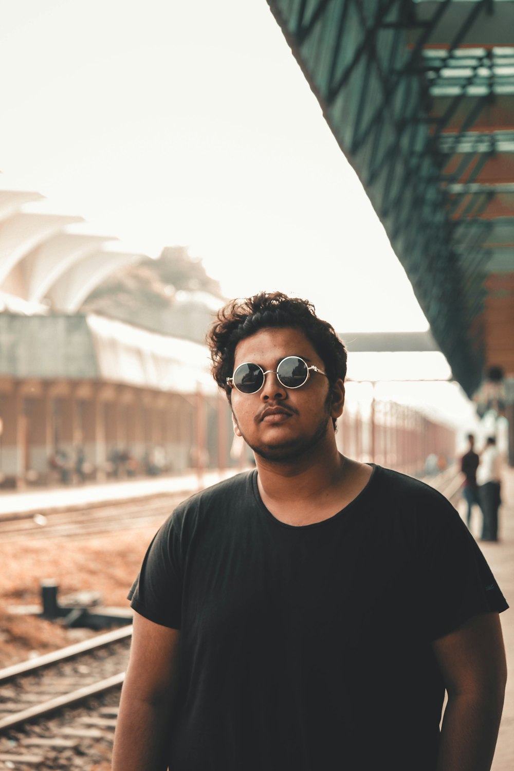 man in black crew neck t-shirt wearing black sunglasses