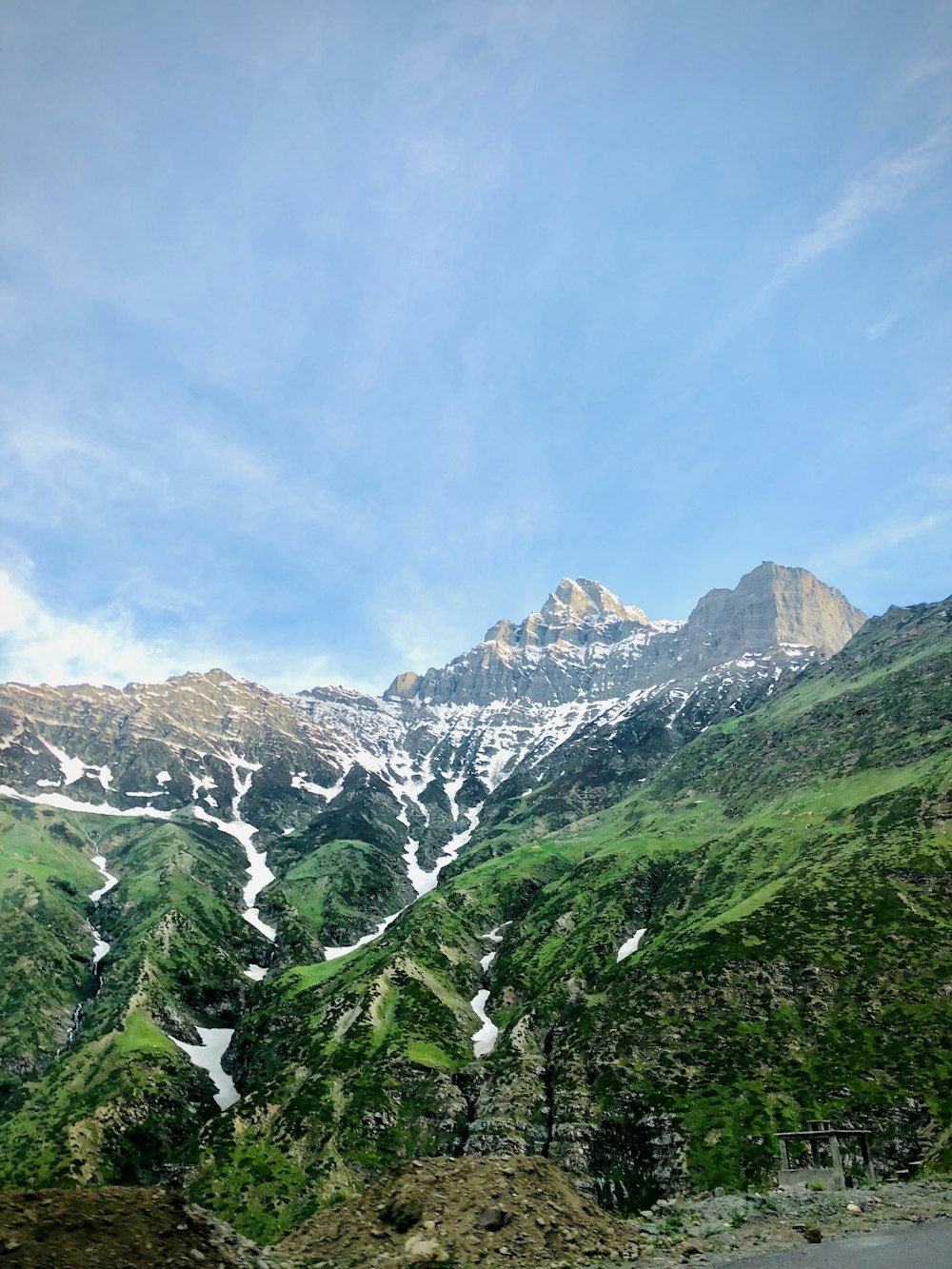 green trees on mountain under blue sky during daytime