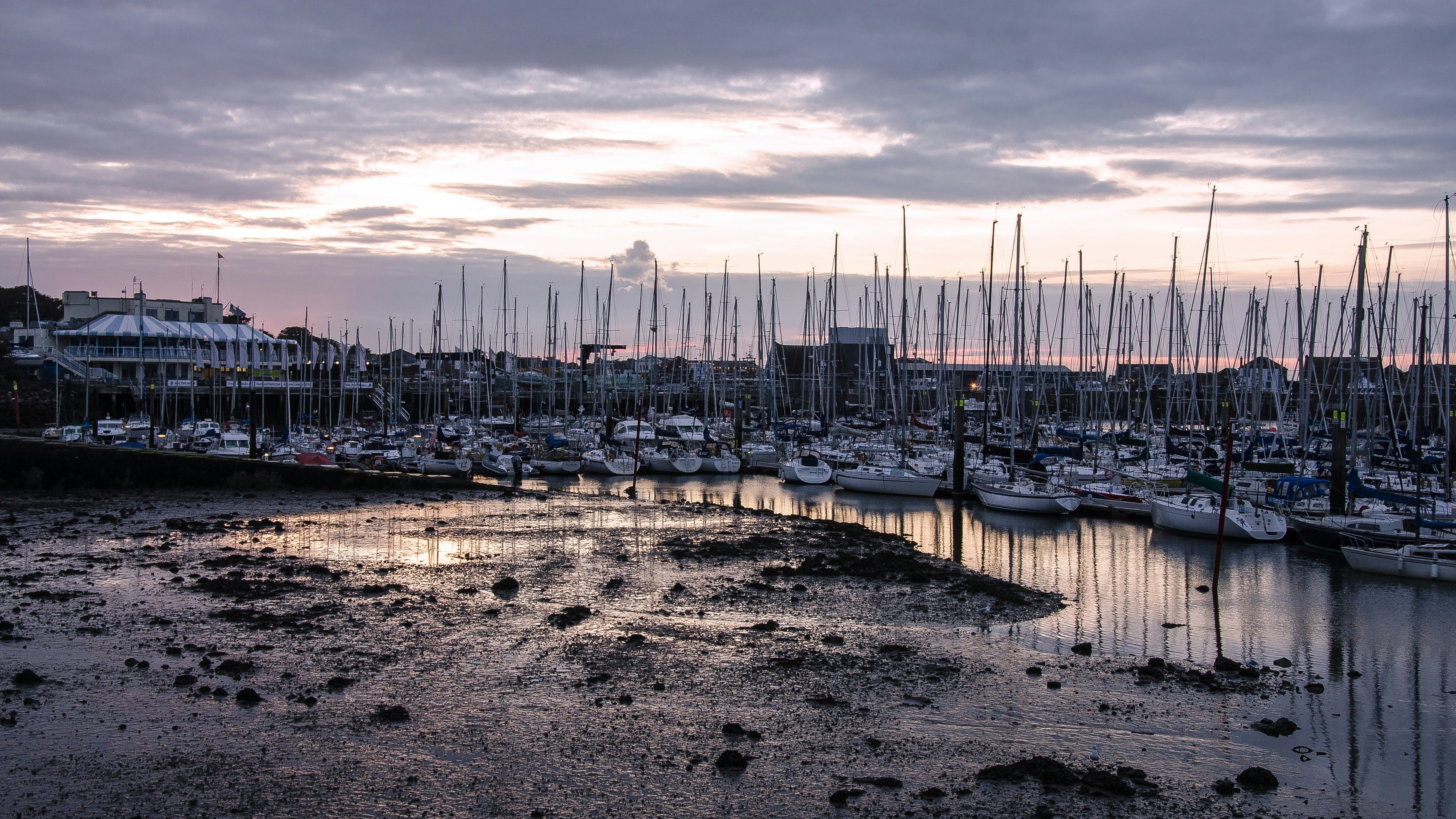 white and blue boat on dock during daytime