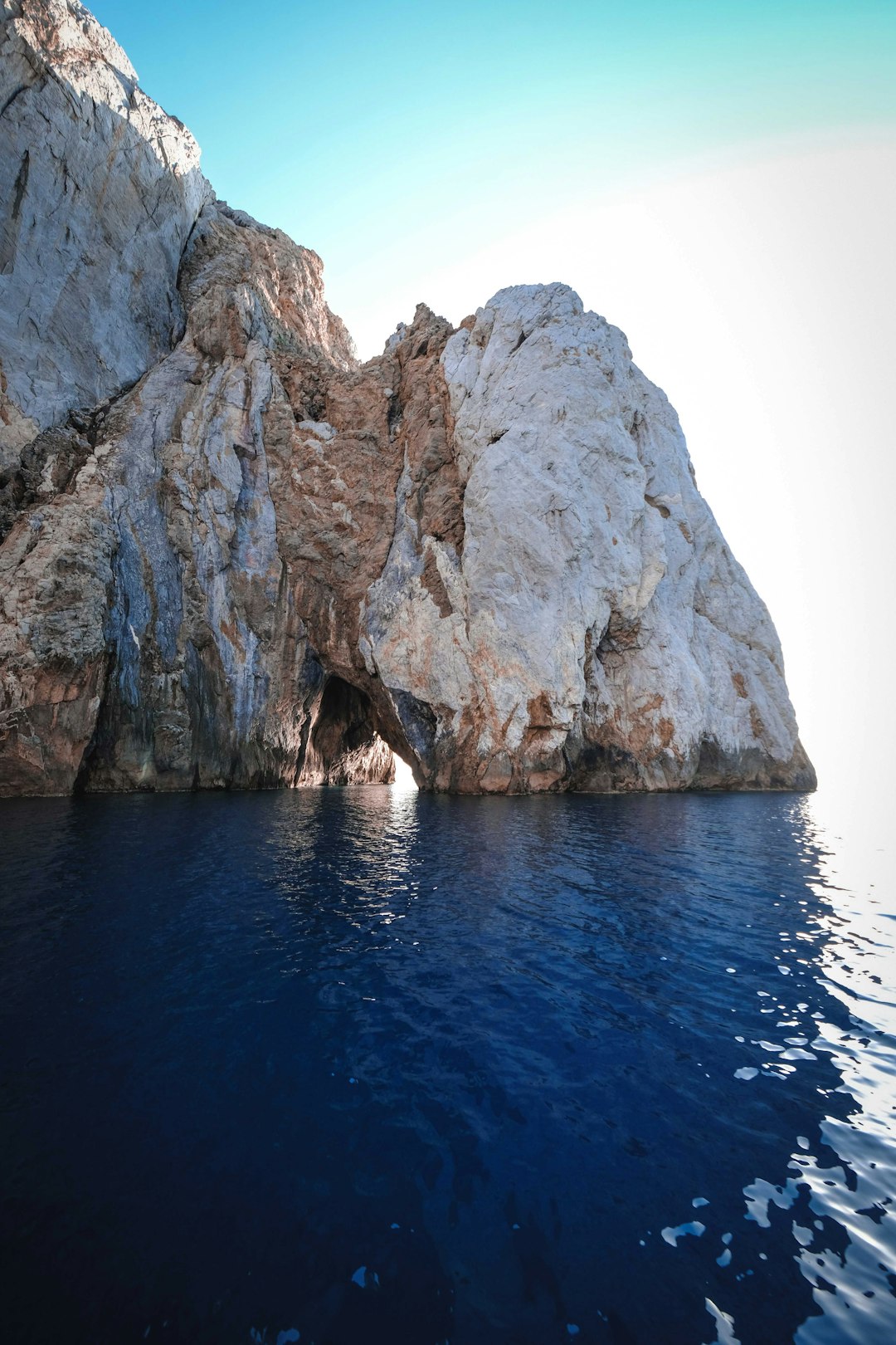 brown rock formation on blue sea during daytime