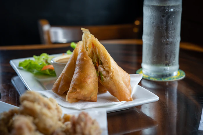 Crispy golden spring rolls with dipping sauce
