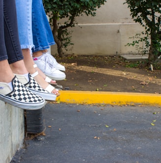 person in blue denim jeans and black and white sneakers