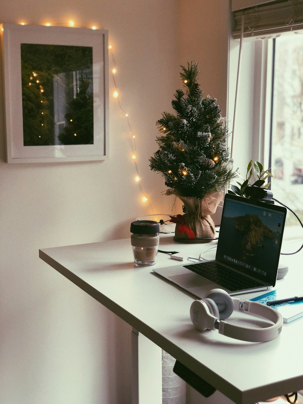 silver macbook pro on white table