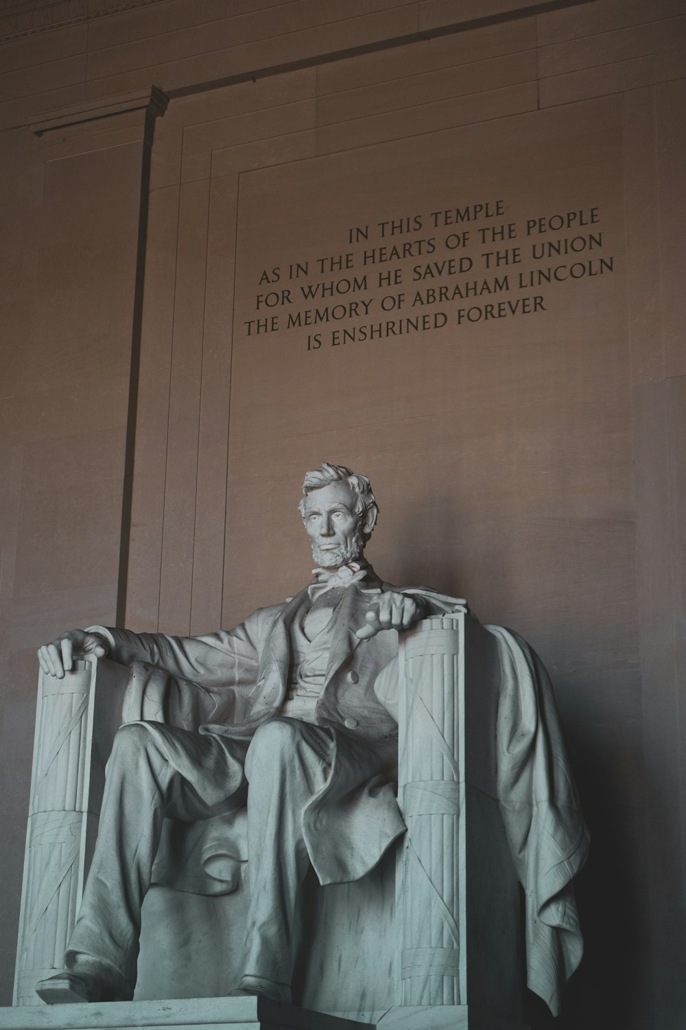 a statue of abraham lincoln in front of the lincoln memorial