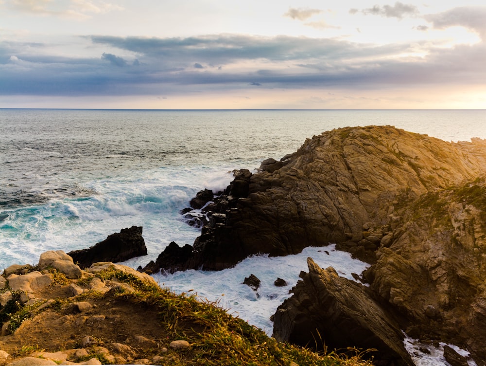 brown rock formation near sea during daytime