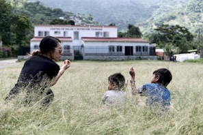 people sitting on green grass field during daytime