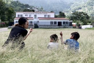 people sitting on green grass field during daytime