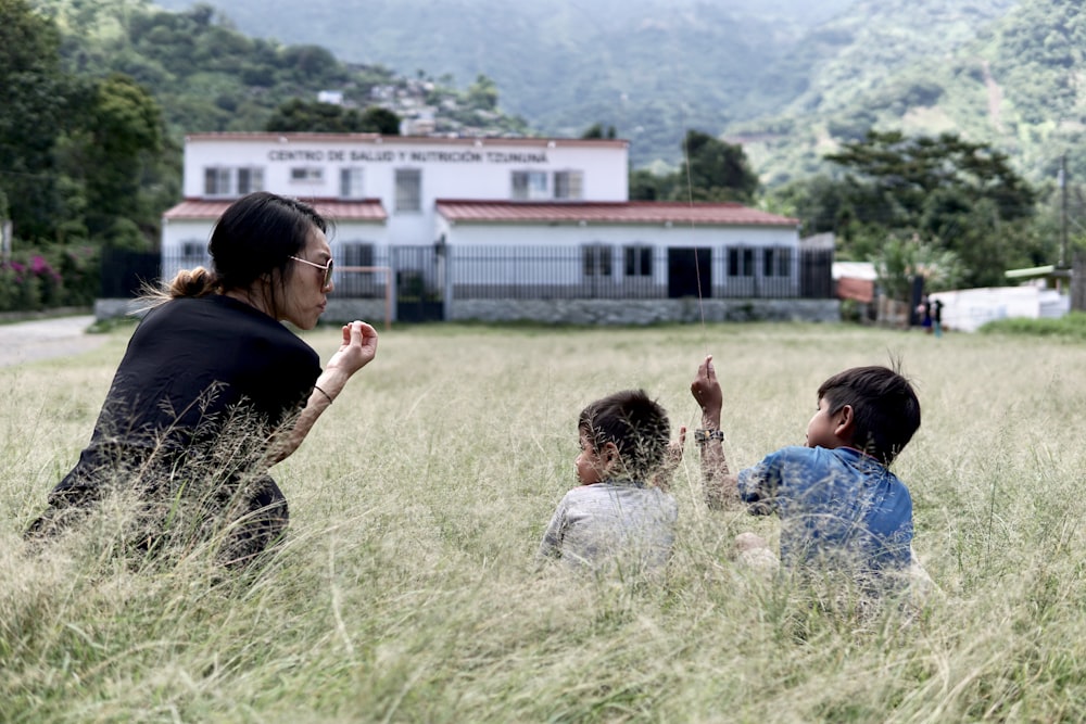 people sitting on green grass field during daytime