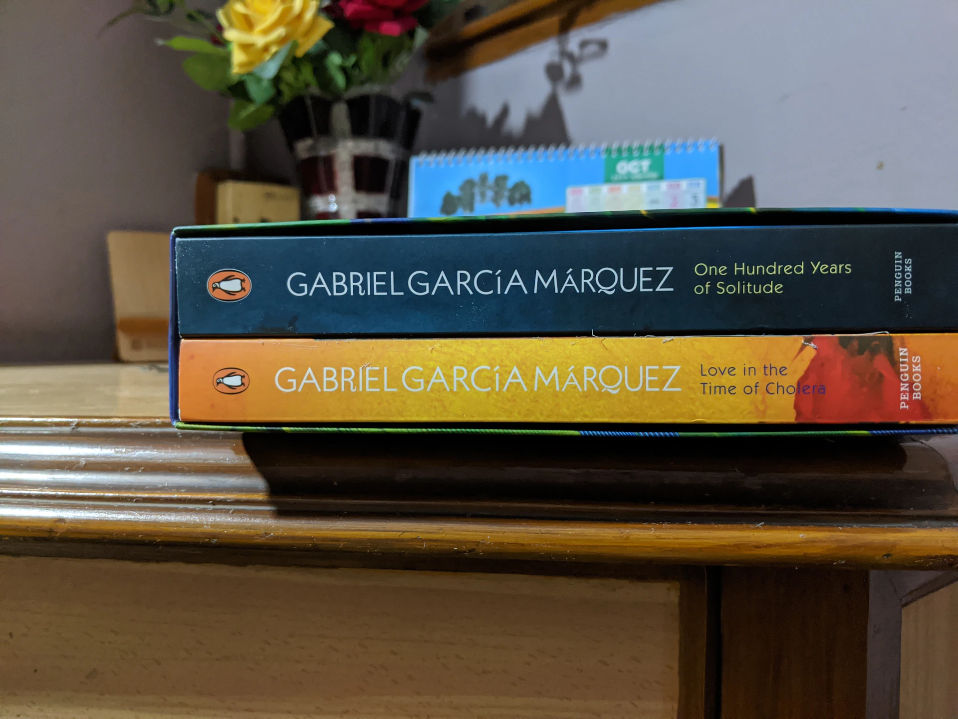 Portrait of Gabriel García Márquez with a warm smile, set against a backdrop of the lush Colombian landscape and a stack of his iconic novels.