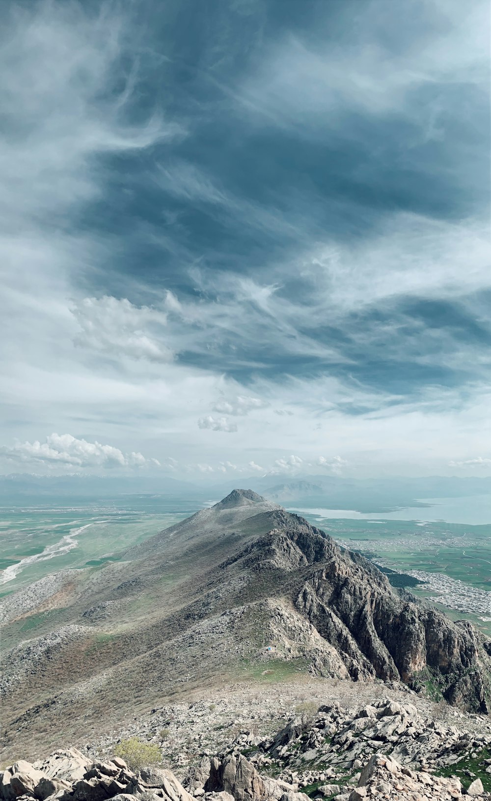 green and brown mountain under white clouds and blue sky during daytime