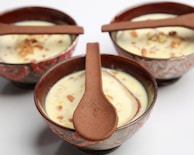 Step-by-step preparation of a creamy dessert in bowls.