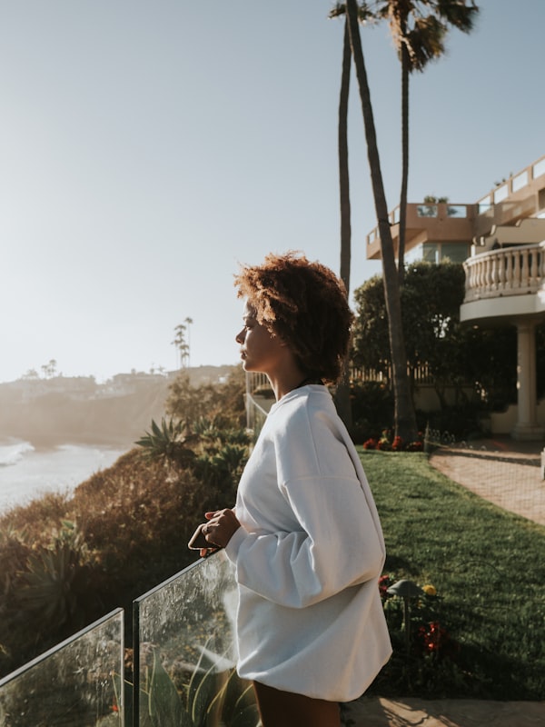 Woman looking over patio at the beach