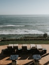 Private terrace with lounge chairs facing the ocean horizon.