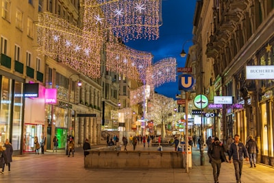 A festive promotional banner hanging above a busy shopping area.