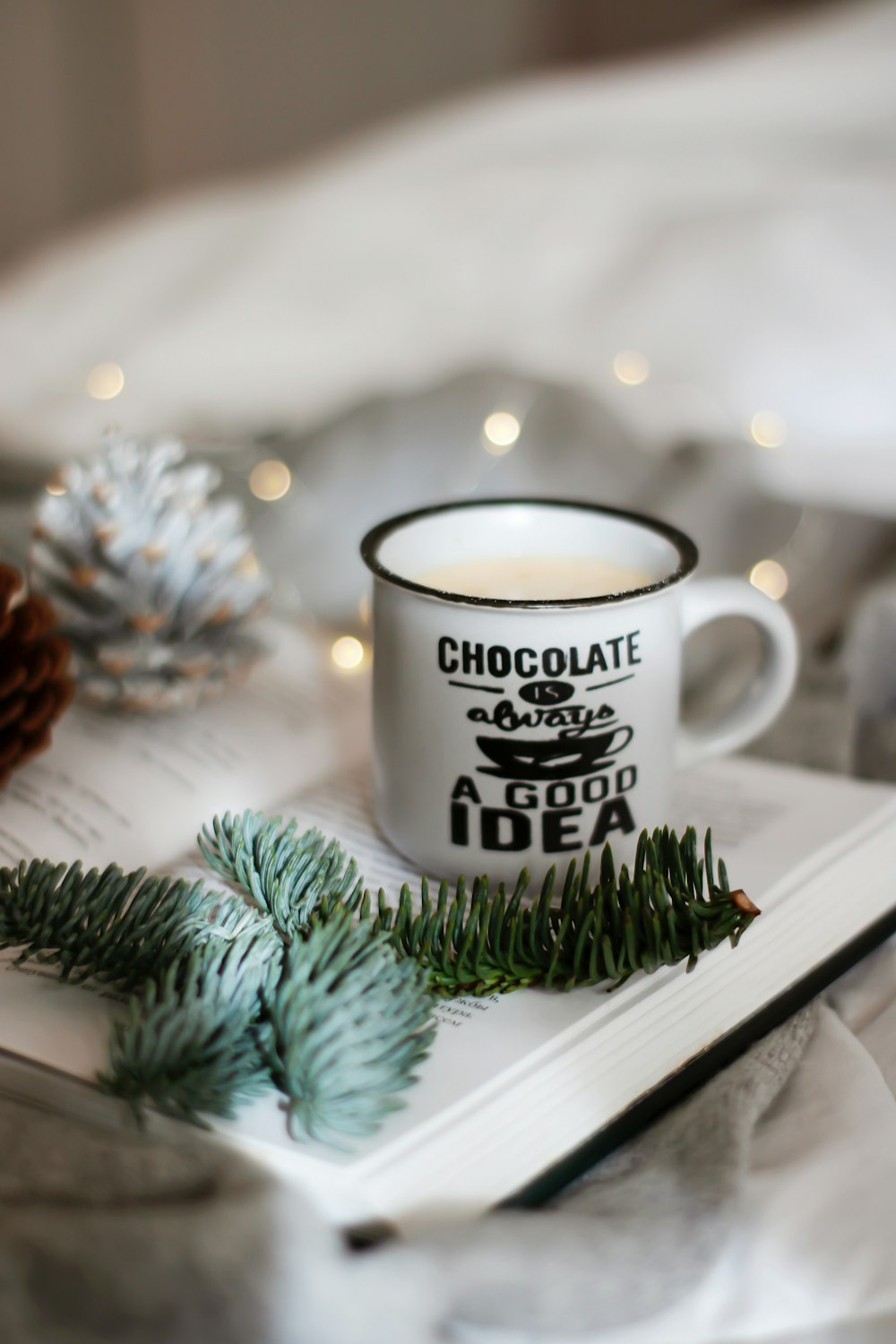 white ceramic mug on white wooden table