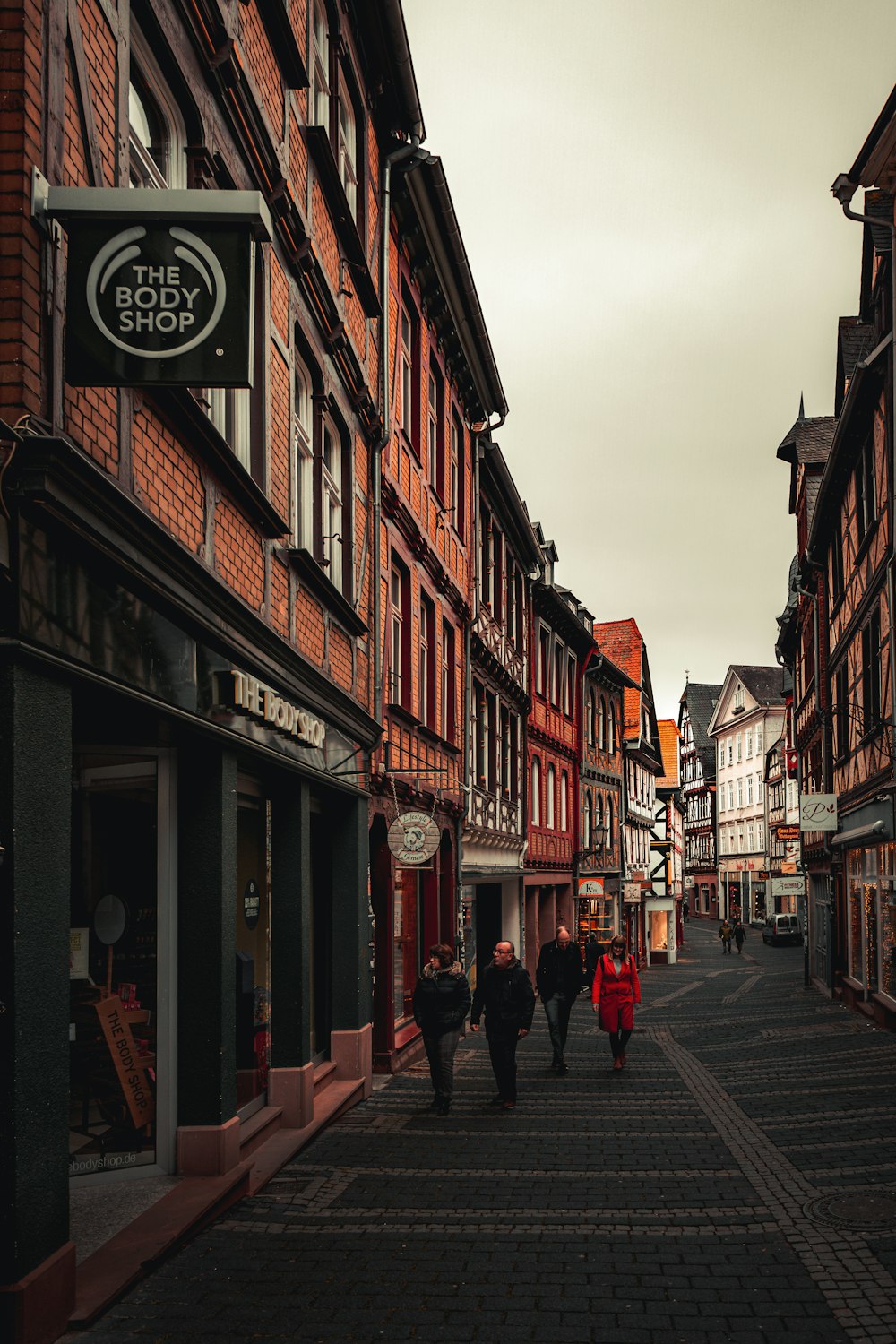 people walking on street between buildings during daytime