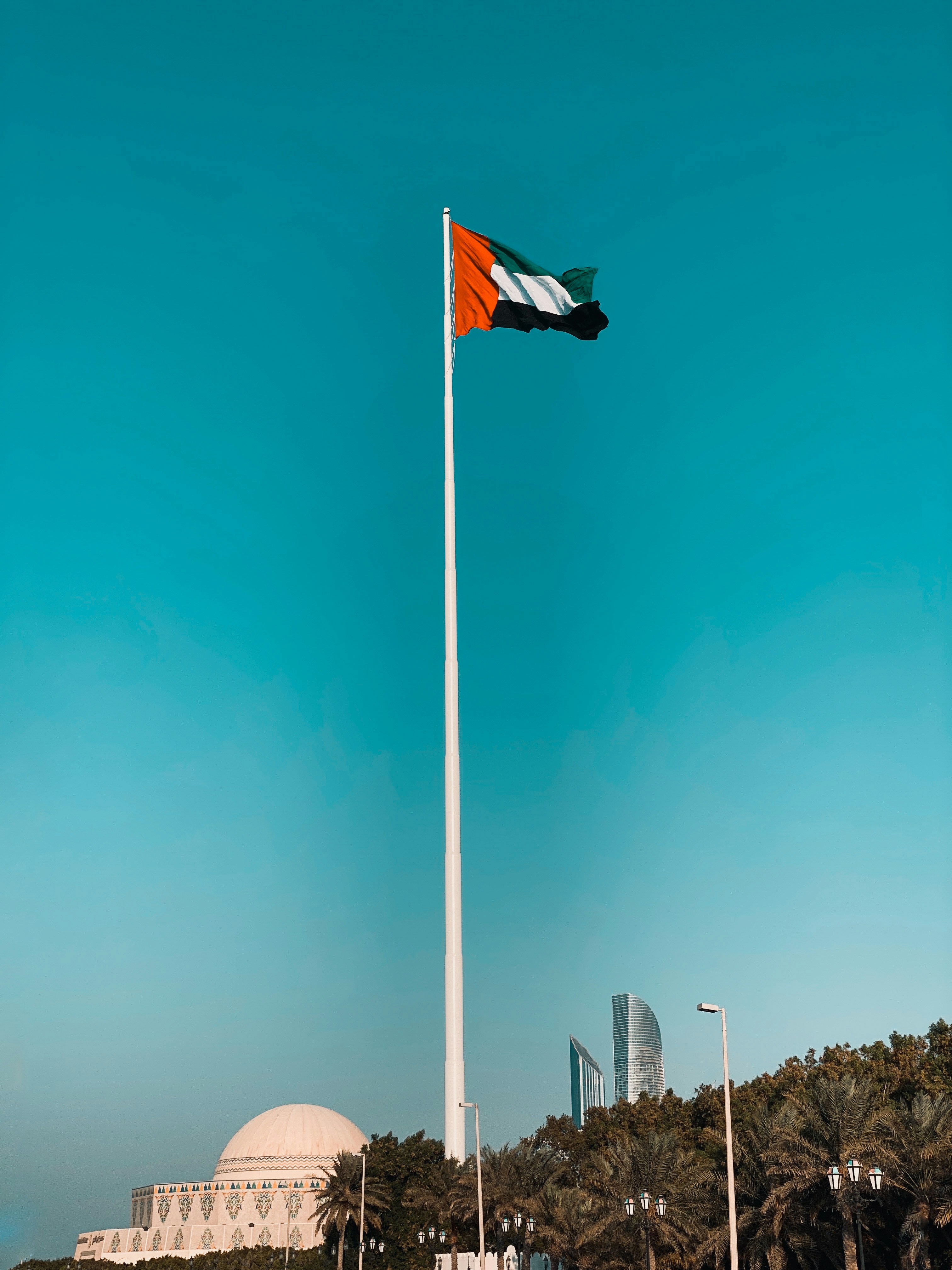 flag of us a on pole under blue sky during daytime