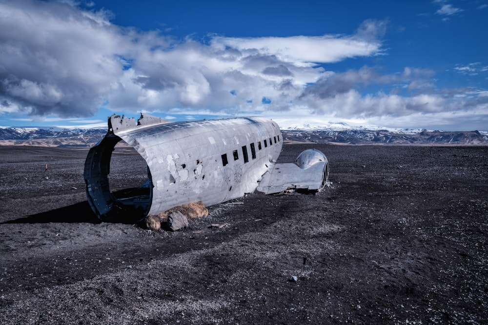 white airplane under white clouds and blue sky during daytime