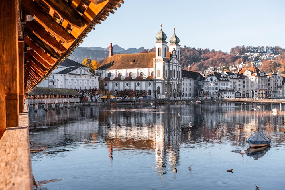 white and brown concrete building near body of water during daytime