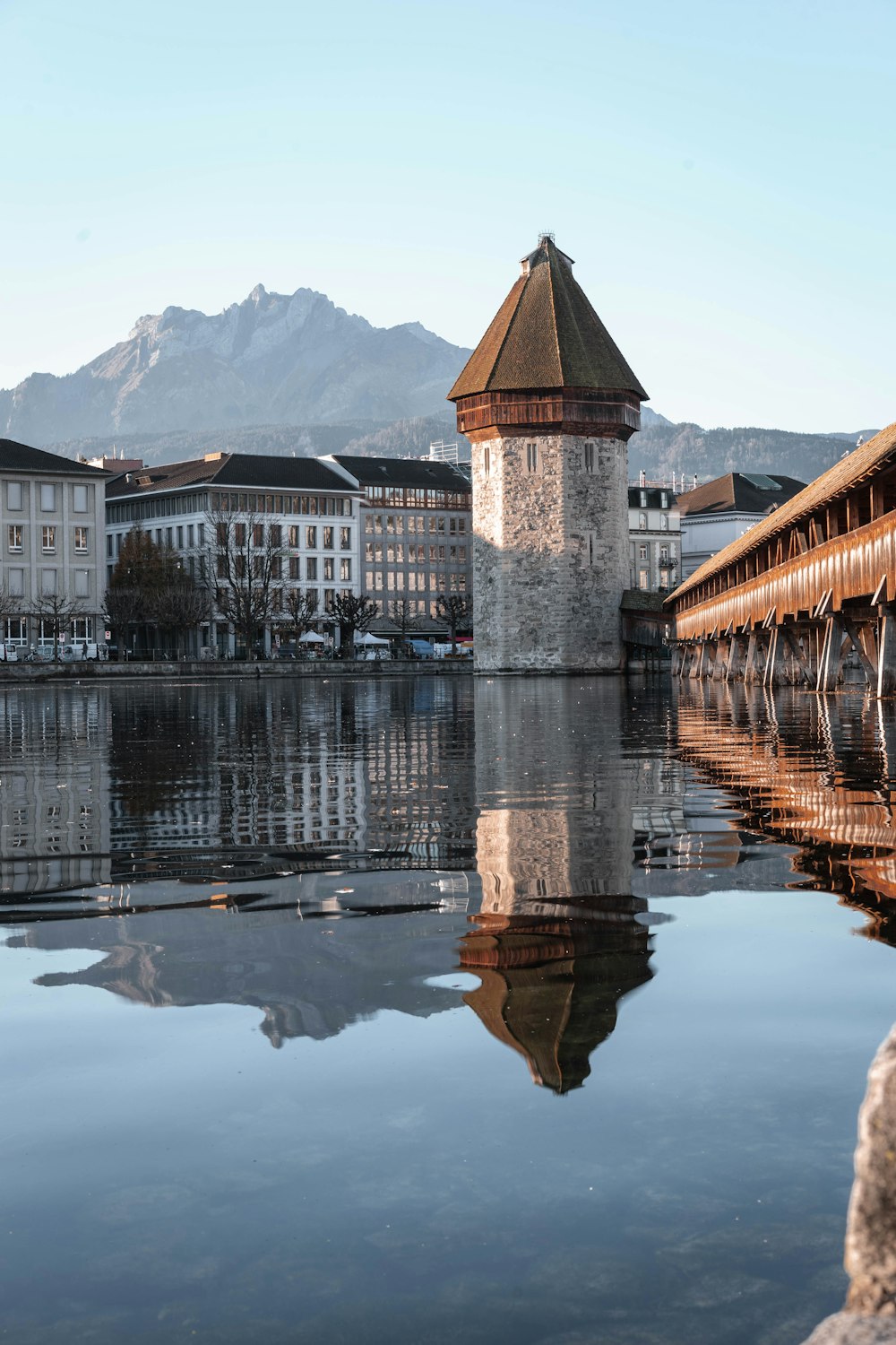 brown and white concrete building near body of water during daytime