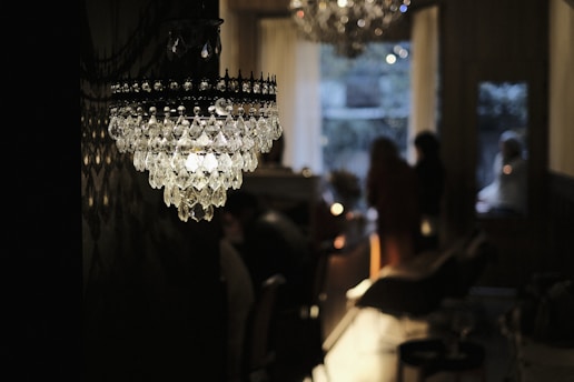 clear glass chandelier turned on in room