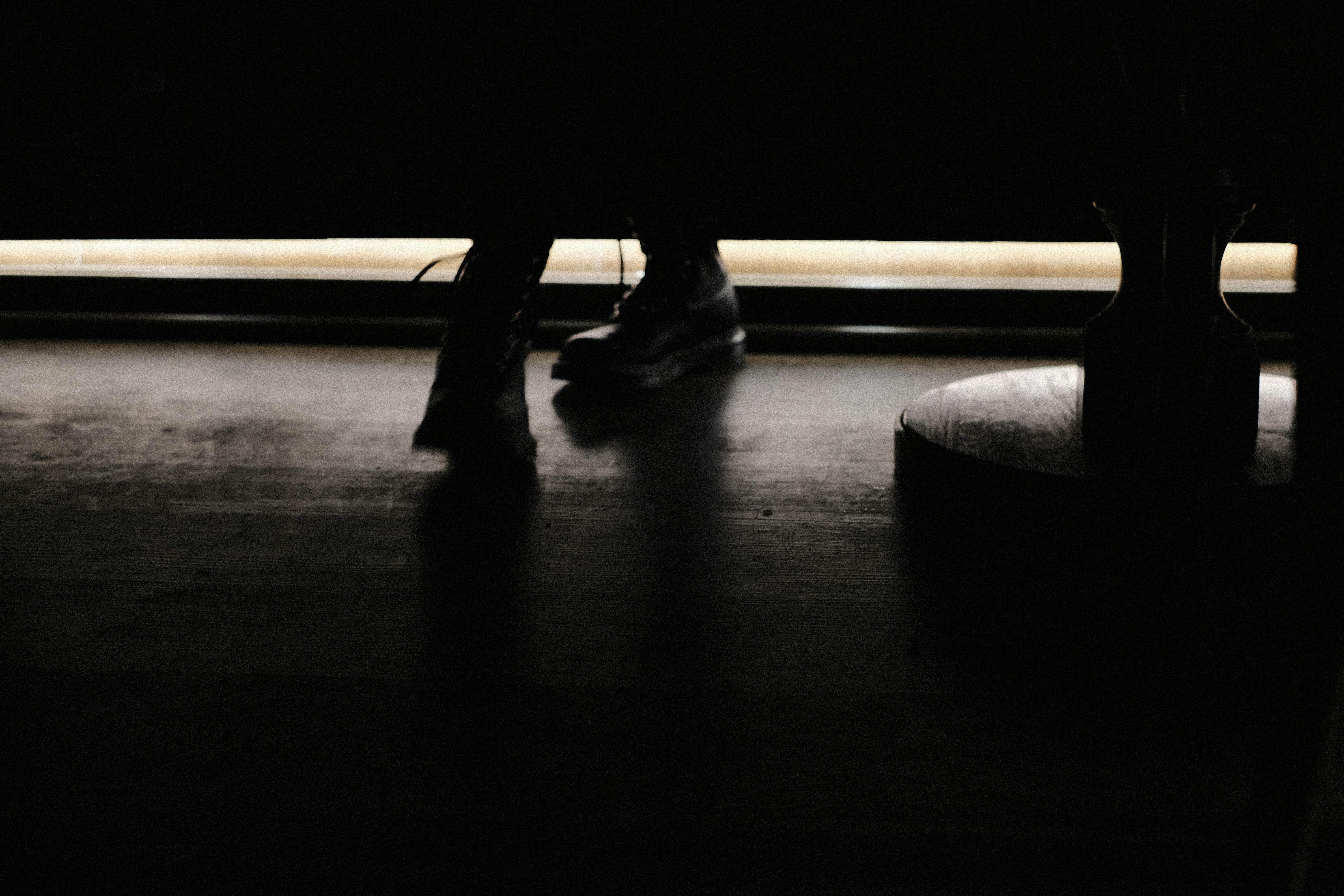 person in black leather shoes