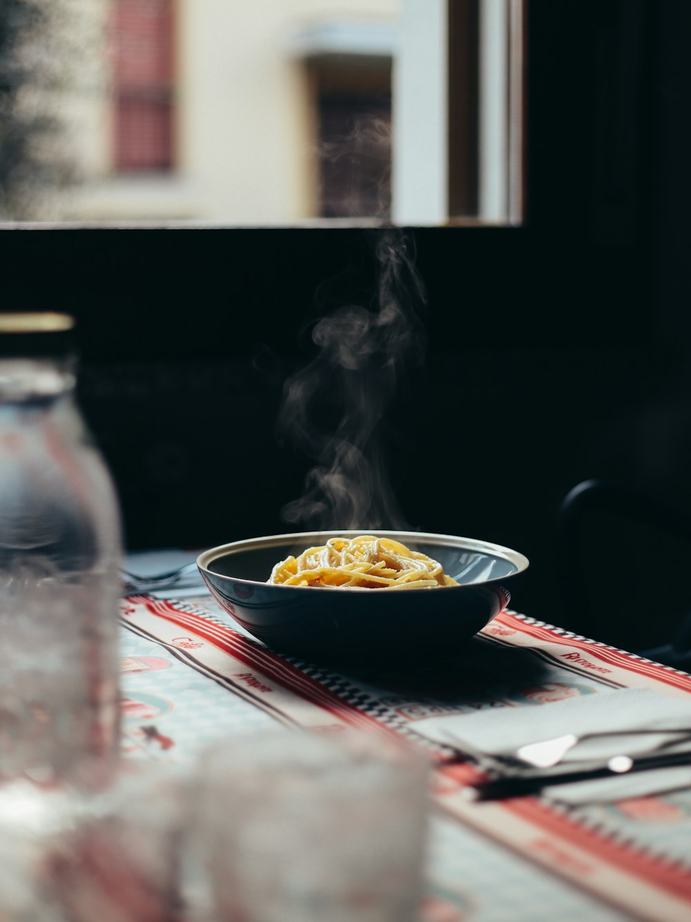 black ceramic bowl on red and white table cloth