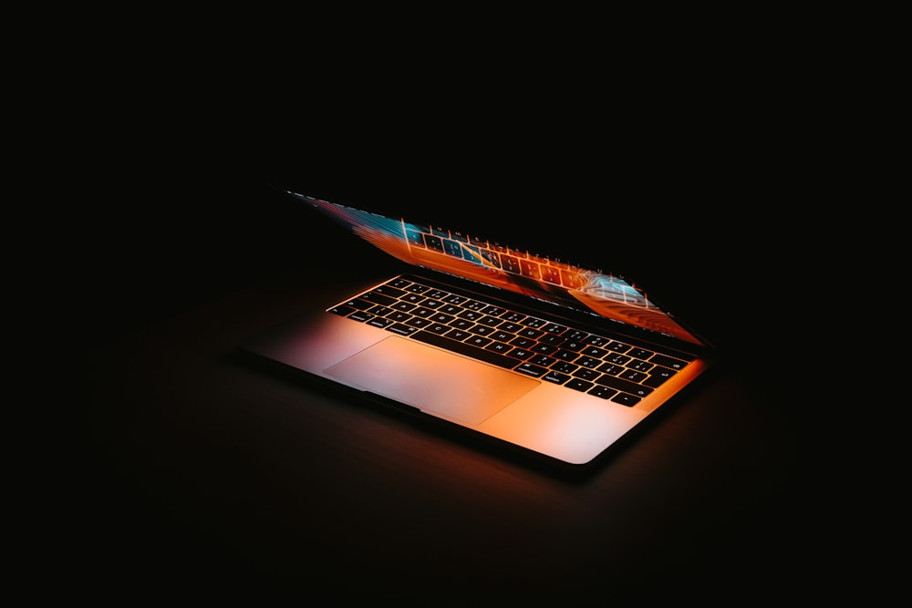 macbook pro on black surface