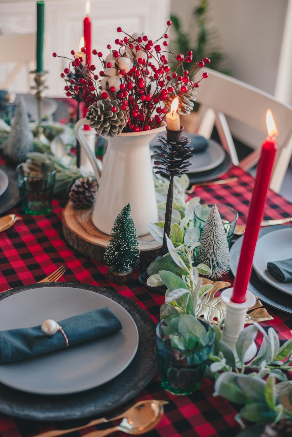 red and white candles on white ceramic vase