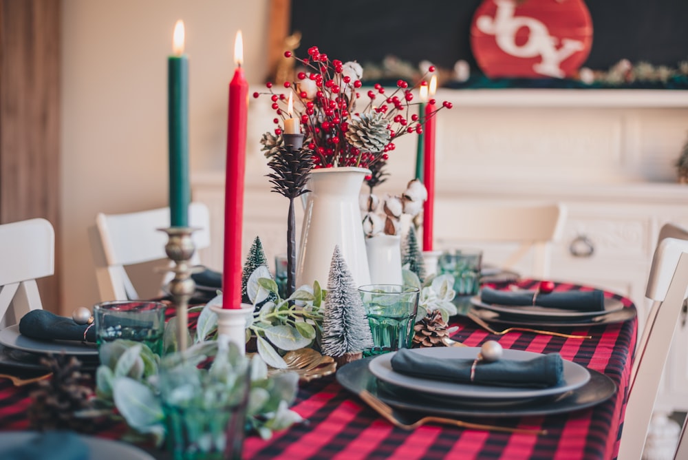 red and white candles on clear glass candle holder