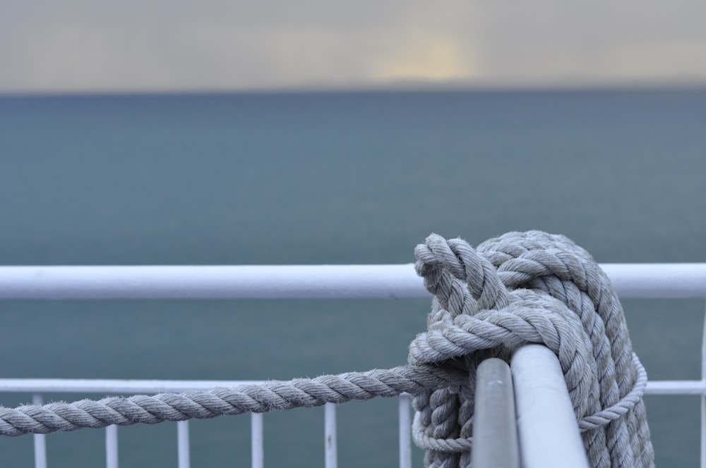 white rope on brown wooden fence