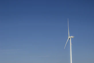 Wind turbine blades spinning against a clear sky, powered by advanced magnets.