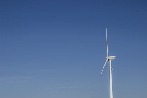 Wind turbine blades spinning against a clear sky, powered by advanced magnets.