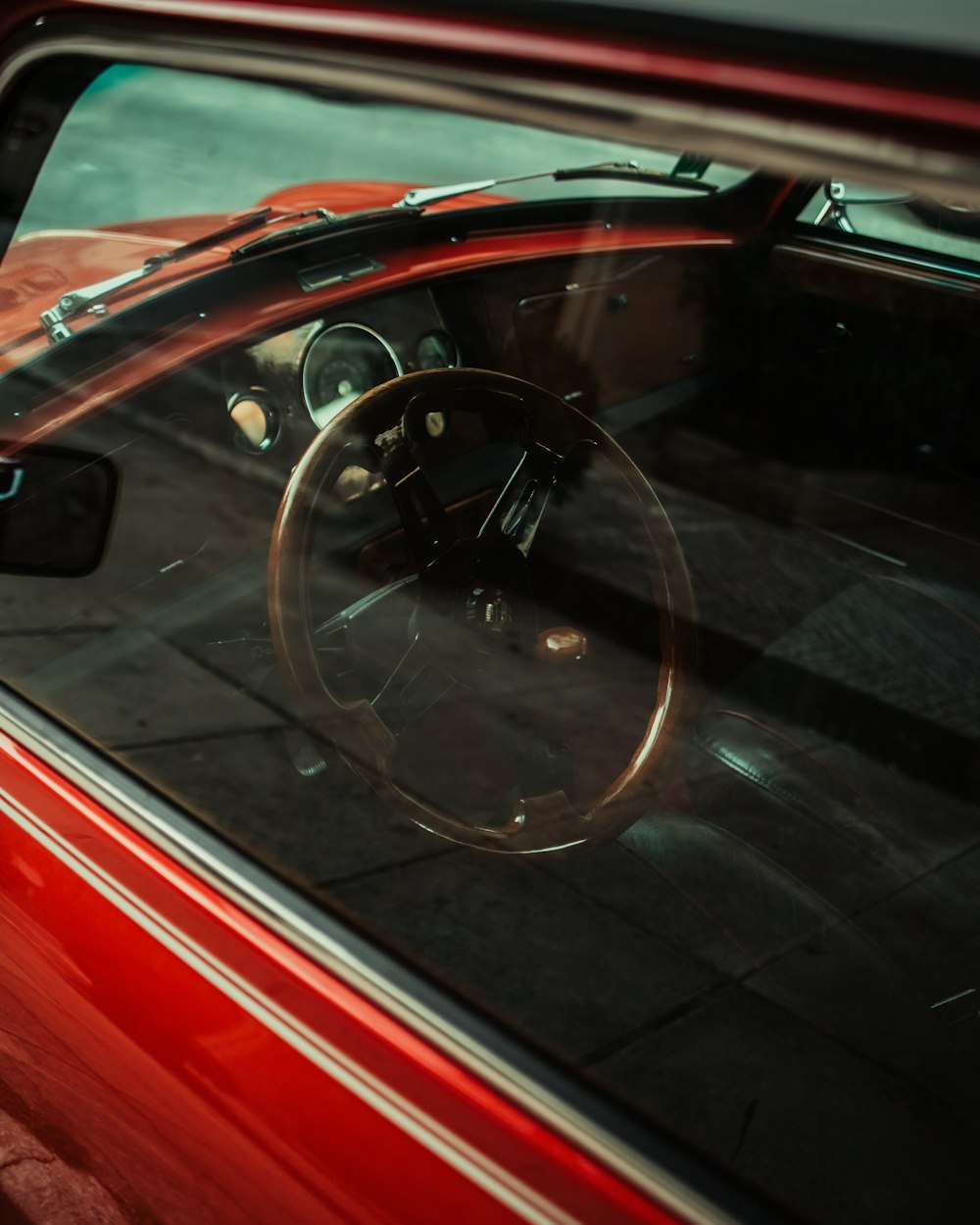 red car with black steering wheel