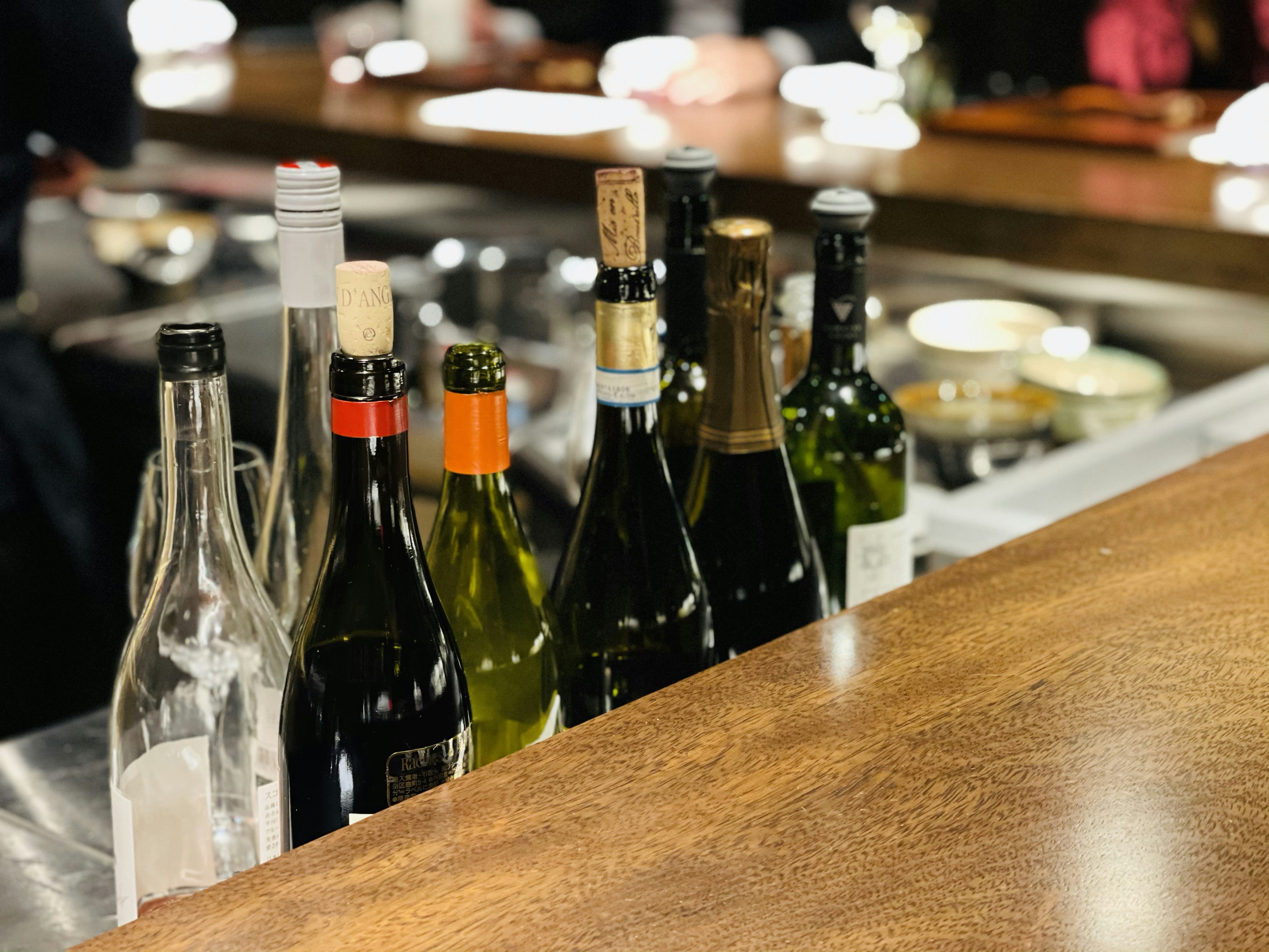 green glass bottles on brown wooden table, 