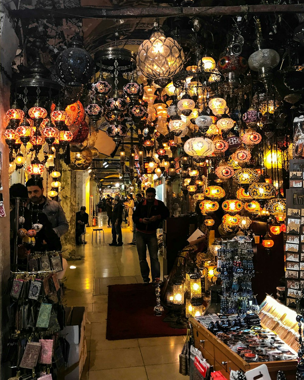 people standing near brown wooden table with lighted pendant lamps